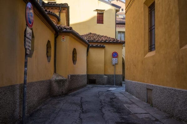Street photography in Bologna Italy, yellow houses.