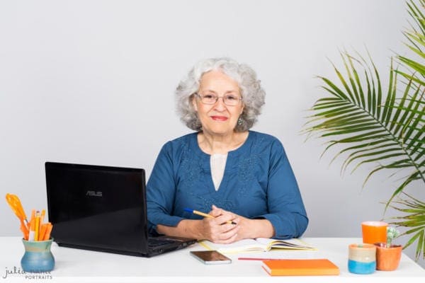 Woman sitting at desk with laptop and stationary - Melbourne corporate and personal branding photography