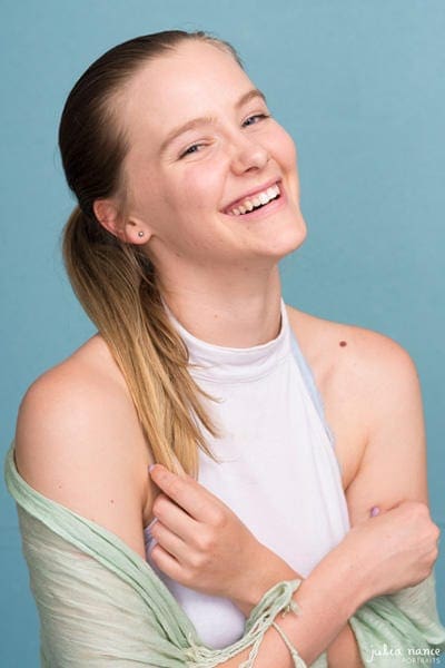 Young woman laughing with blue background - Melbourne personal branding headshot photography