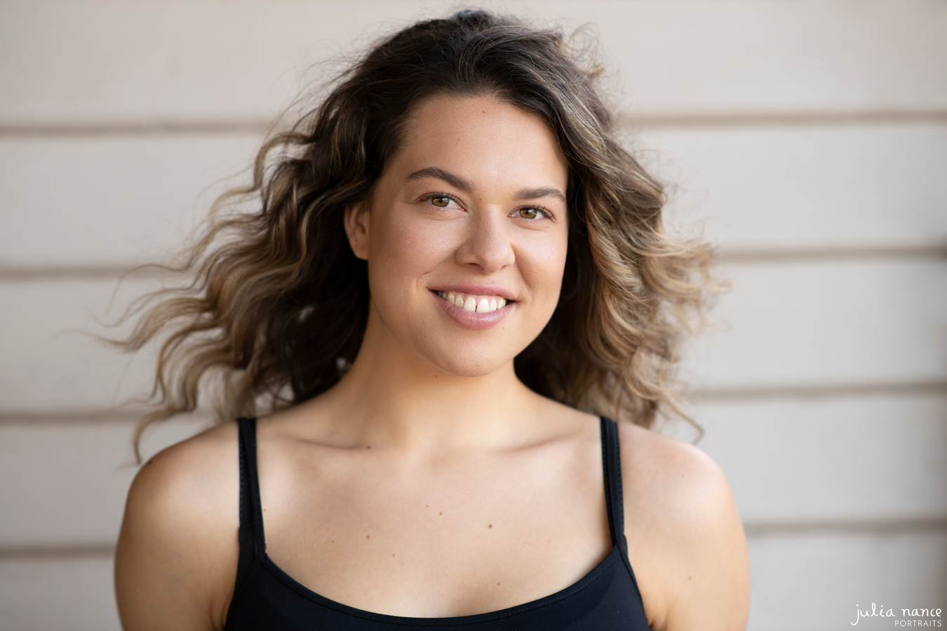 natural light headshot of melbourne actor smiling to camera.
