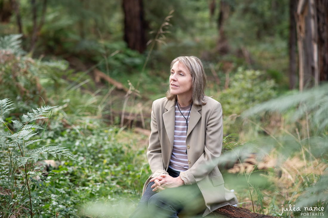 Woman seated outside amongst nature in a relaxed candid personal branding portrait
