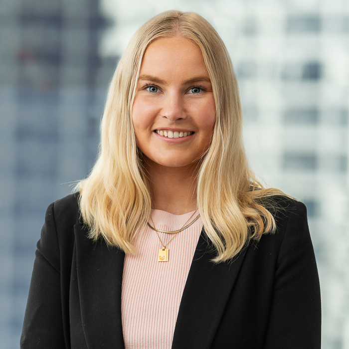 Corporate staff headshot of melbourne lawyer with city skyline background.