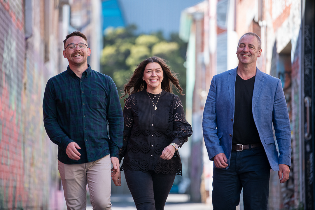 team of staff outside in Melbourne alleyway for staff headshot