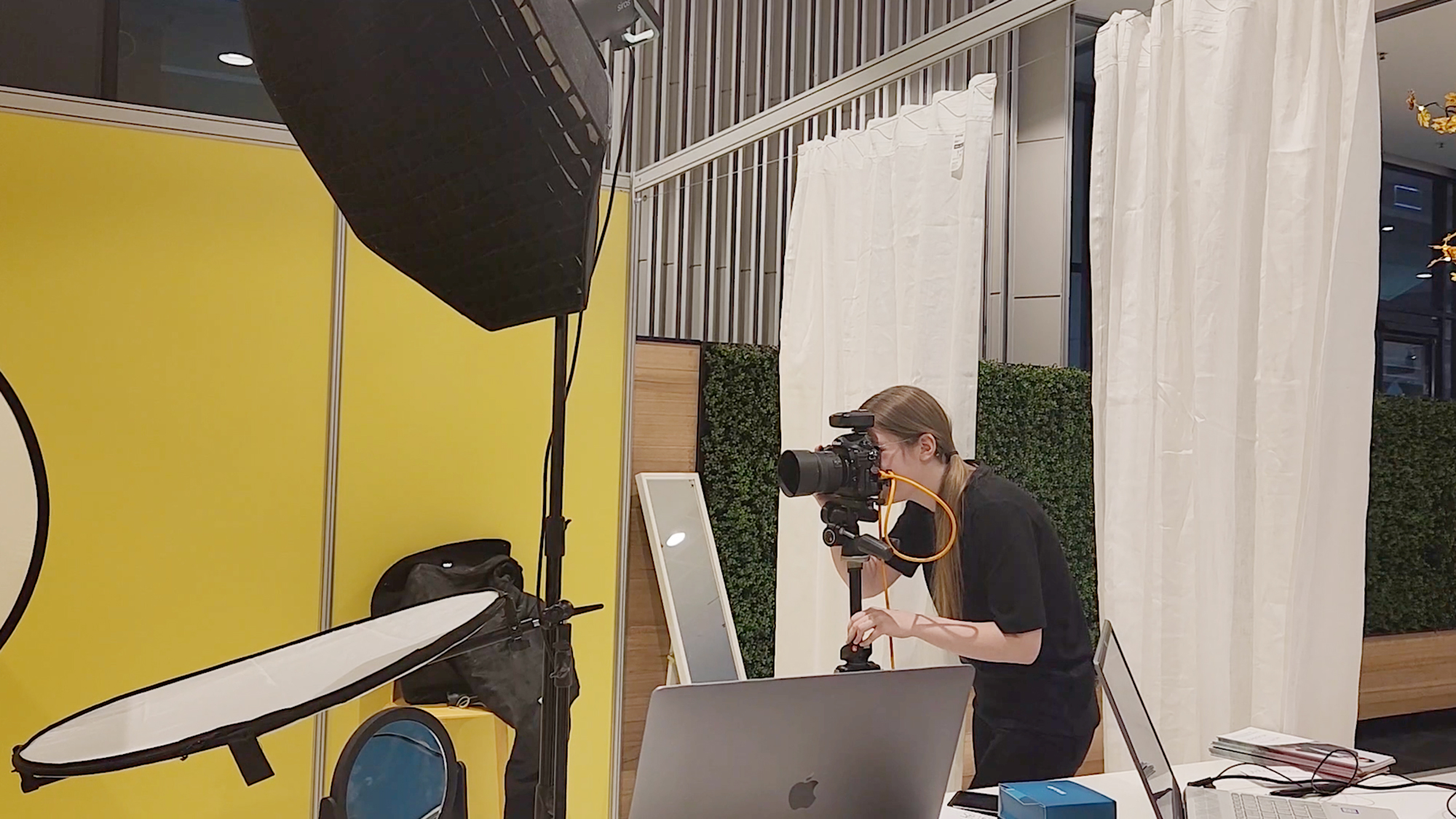 Behind the scenes image of Julia photographing at the small biz expo 2022