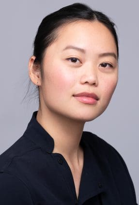 Melbourne actress looks up at camera with a relaxed expression for a clean studio headshot.