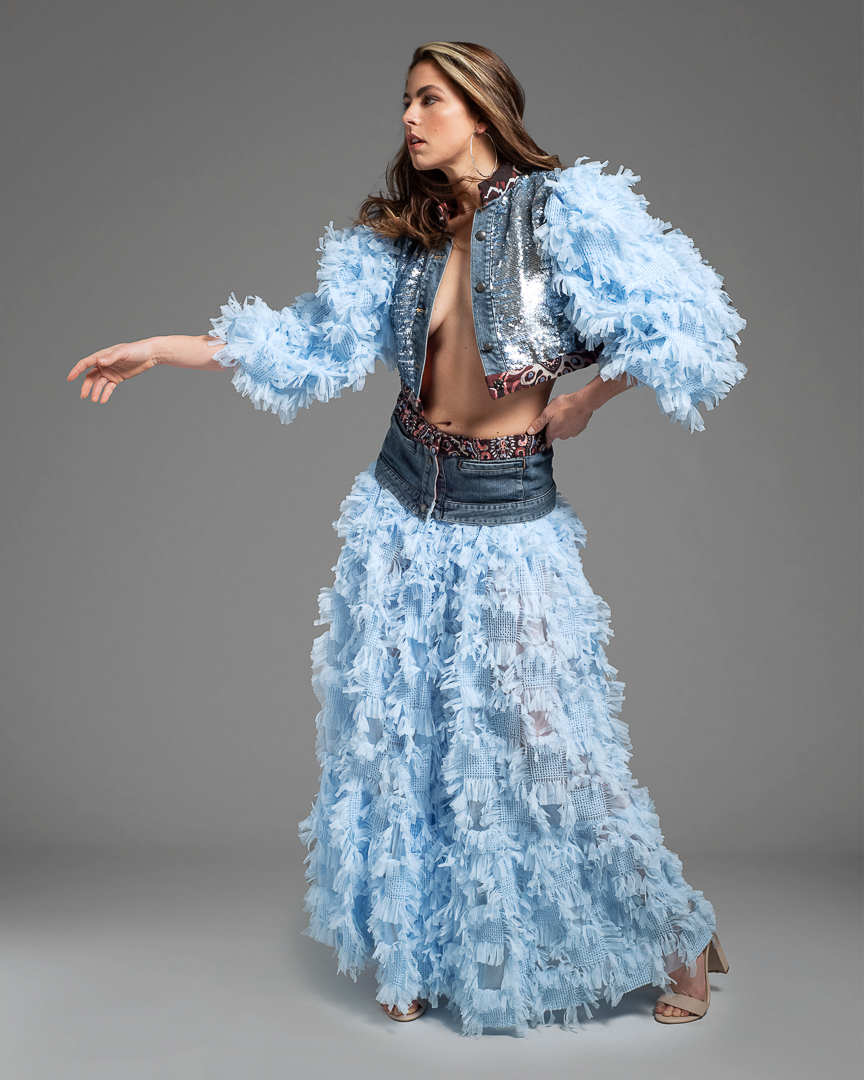 High end fashion photography of Melbourne model wearing a hand made denim jacket and skirt, complete with feather detail.