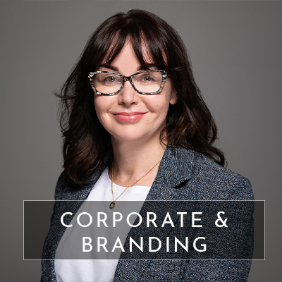 A professional corporate headshot of woman on a grey background. Text overlays the image that says "corporate and branding".