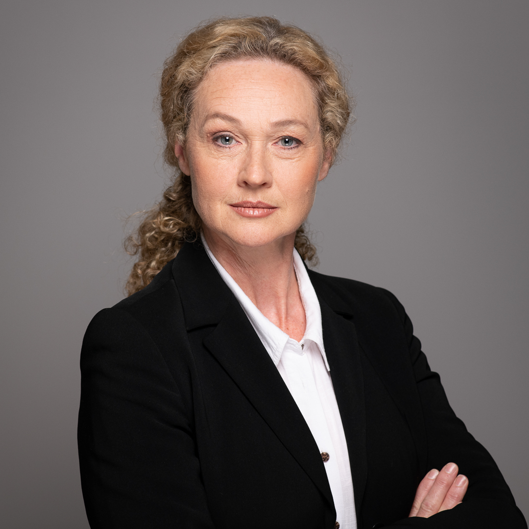 A confident corporate portrait of woman with her arms crossed and a serious expression. This portrait was for an actor headshot portfolio to demonstrate different characters.
