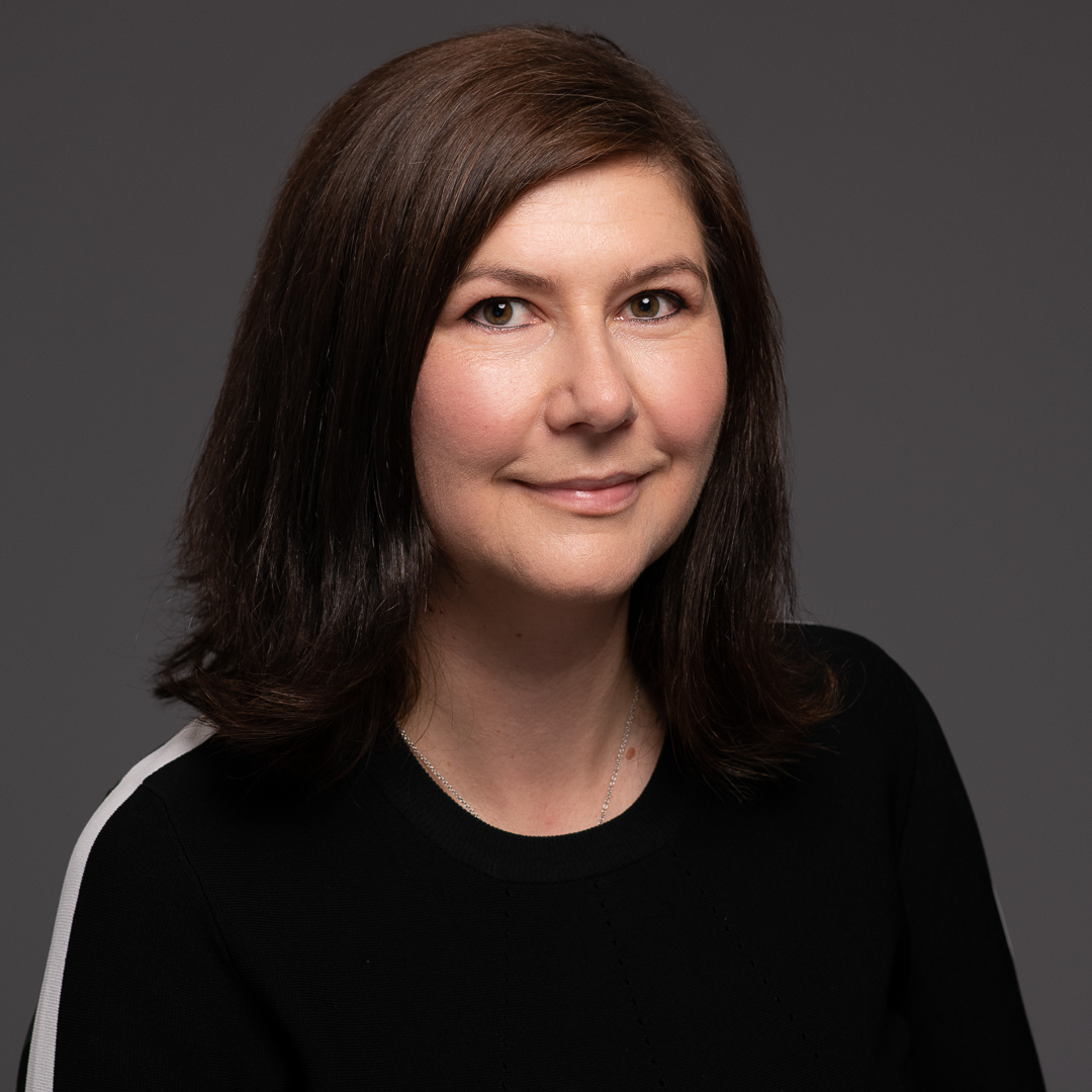 Professional linkedin headshot taken in melbourne studio of woman smiling to camera with confidence.