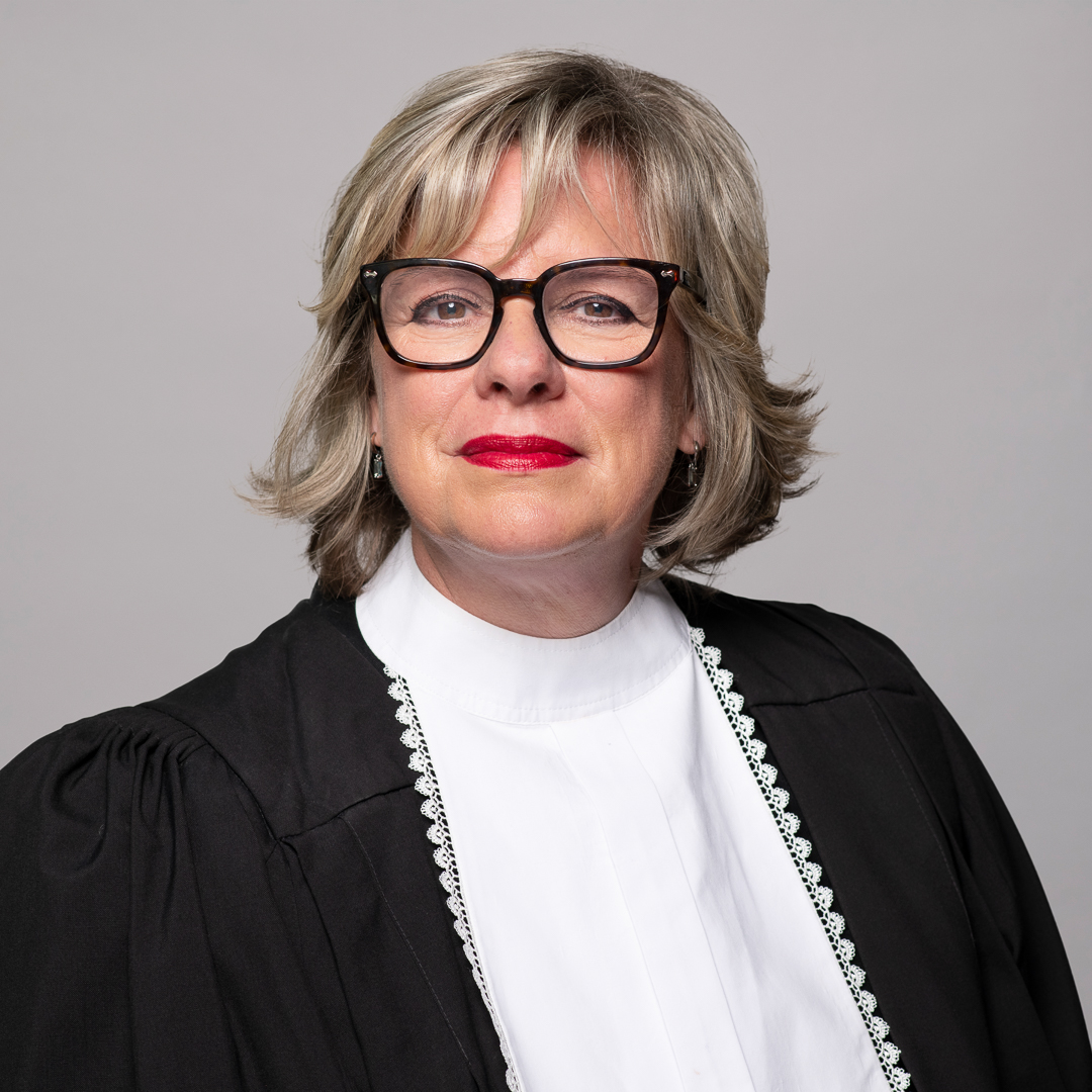 Melbourne barrister headshot of woman smiling confidently to camera wearing formal barrister robes.