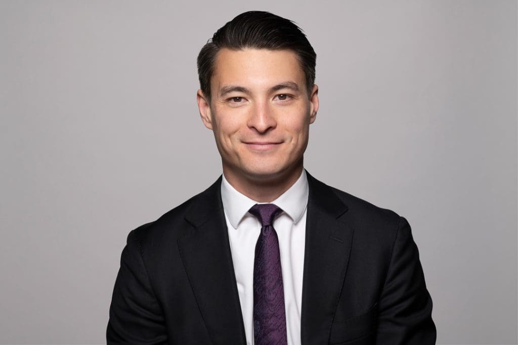 Melbourne barrister headshot of man smiling to camera wearing a suit and tie.