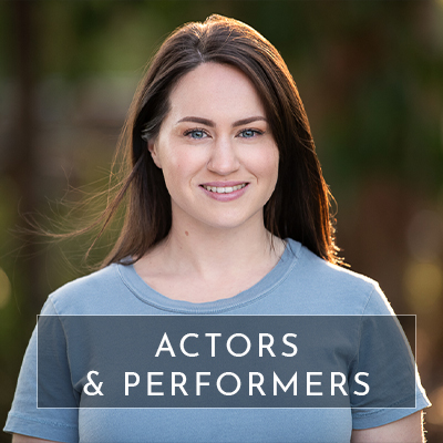 Text overlays the image saying "Actors & performers". Behind the text is a headshot of a woman smiling to camera in an outdoor setting. This image is used to redirect you to a page with information for people needing actor headshot photography (including dancers and other performers).
