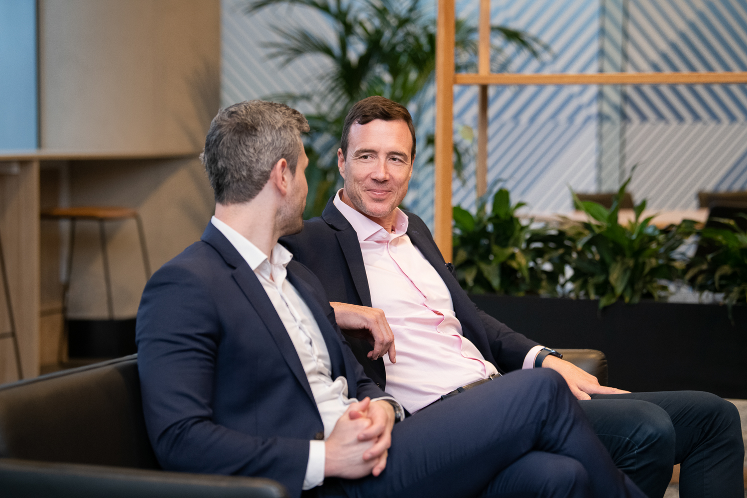 Personal branding photography of melbourne business - in-situ and working together in a collaborative way. Two business men engage in discussion while seated.