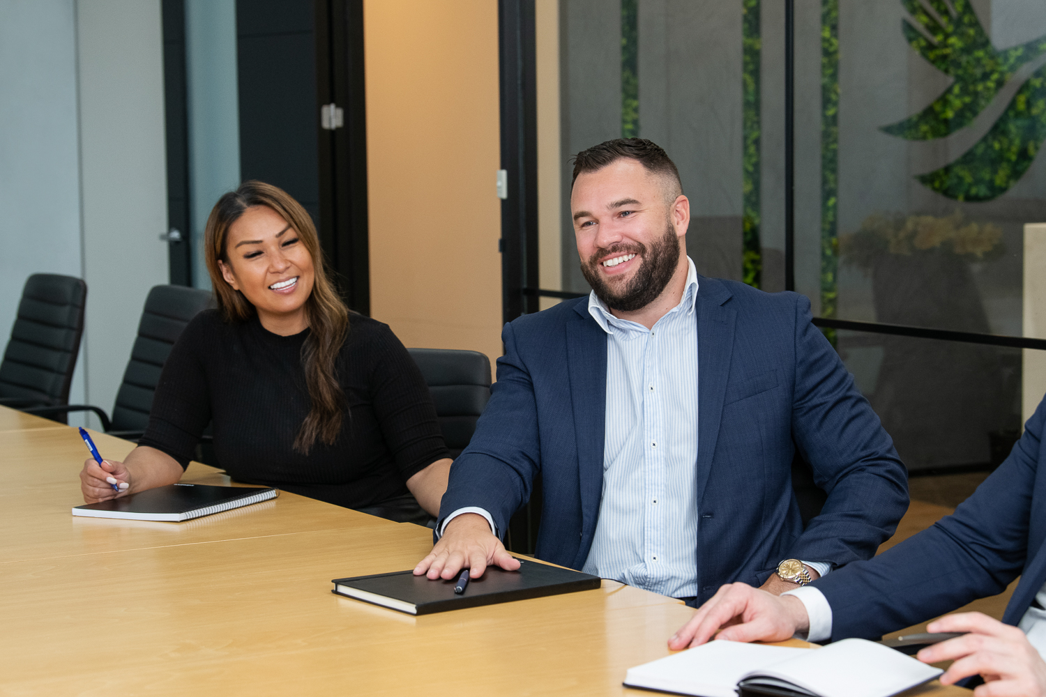Personal branding photography of melbourne business - in-situ and working together in a collaborative way. Man and woman smiling during a boardroom meeting.