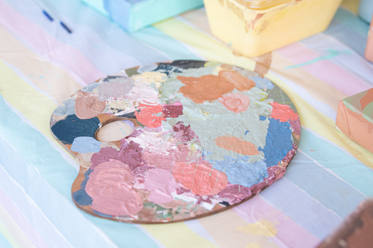 Close up detail image of artist paint palette, filled with colours.