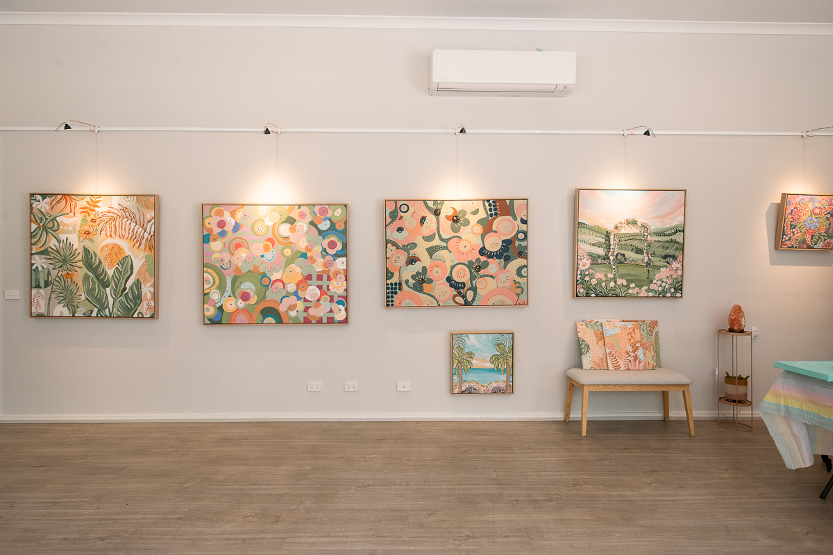 Interior photography of Melbourne gallery space Aurora Art showing 5-6 artworks framed on the wall.