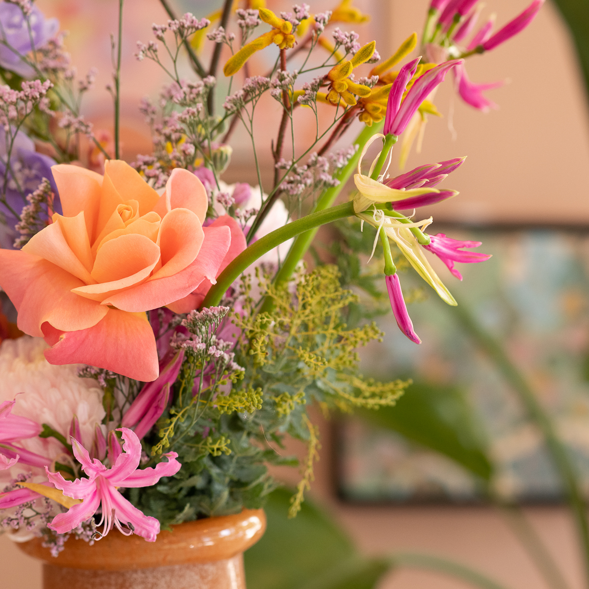 Detail image of colour flowers sitting in a vase.